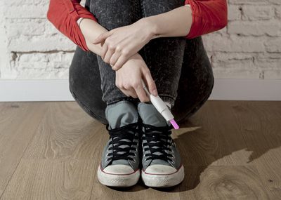 What Should You Do if You Are Pregnant and Addicted - young woman with pregnancy test