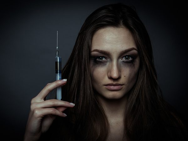 Why Addicts Can’t "Just Stop" - addict woman holding needle