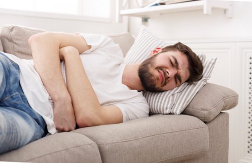 What to Expect During Alcohol Detox if You’re a Long-term Drinker - man sick on the couch