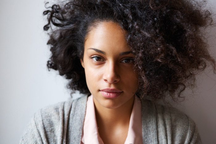 beautiful Black woman looking into camera - women and addiction