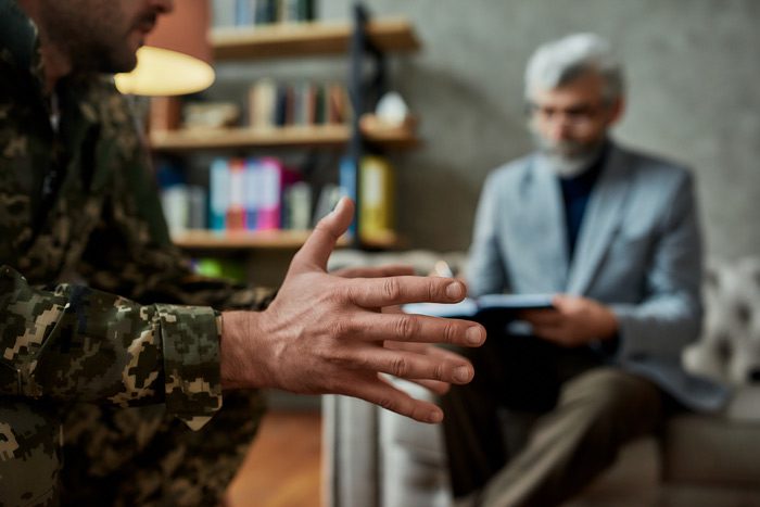 man in army fatigues at psychologist - PTSD and veterans - addiction